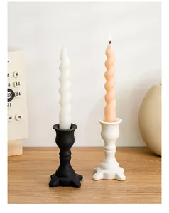 Detailed view of Nordic ceramic candle holders in black and white with spiral candles
