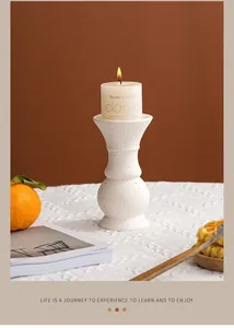 Detailed shot of a modern white ceramic candle holder with artistic black splatter texture