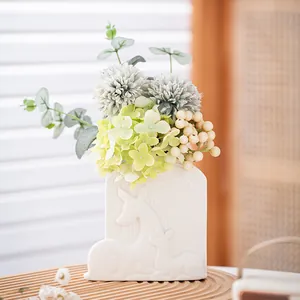 Elegant white ceramic flower vase with embossed deer motif and artificial hydrangeas
