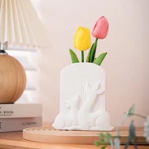 Elegant white ceramic vase with embossed deer relief in a warm cozy home setting