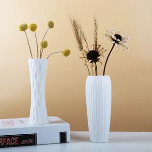 Minimalist white ceramic vase set with unique textured geometric and ridged patterns