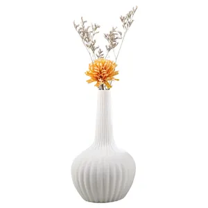 Minimalist white ceramic ribbed vase for modern home decor and floral arrangements.
