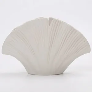 White ceramic vase with a minimalist ginkgo leaf shape for modern home decoration