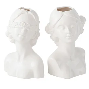Elegant pair of modern white ceramic female bust vases with minimalist face design