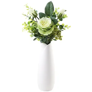 Modern white ceramic vase with artificial green rose and foliage for elegant home decor