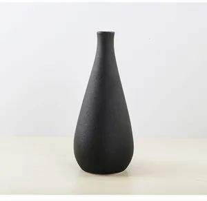 Detail of an elegant black matte textured ceramic vase with a narrow neck design for home decor