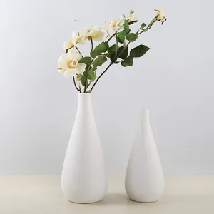Minimalist white ceramic vase set with artificial white roses for modern home decor
