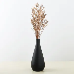 Modern Nordic black matte ceramic vase with dried flowers for minimalist home decor