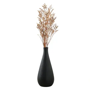 Modern minimalist black ceramic vase with elegant dried flowers for home decor