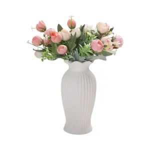Modern Nordic white ribbed ceramic vase with elegant pink and white rose bouquet