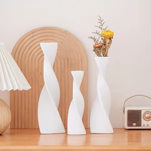 Set of three modern white spiral ceramic vases for elegant home tabletop decor