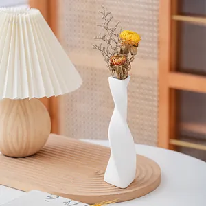 Elegant white twisted ceramic vase for minimalist home decor and floral arrangements
