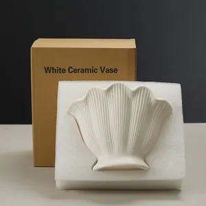 Elegant white shell-shaped ceramic vase with protective foam and cardboard packaging box.