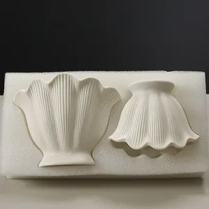 Elegant minimalist shell-shaped ceramic vase set featuring refined ribbed texture