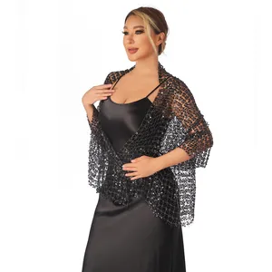 Detail view of an elegant black water-soluble lace shawl with sequins for evening gowns