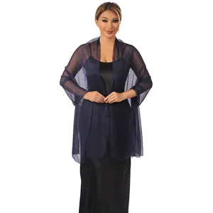 Detailed view of elegant navy blue sheer tulle shawl worn over a black dress