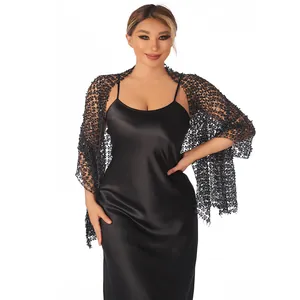 Detail view of black sequin lace shawl wrap accessory for evening gowns and party wear.