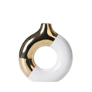Modern donut ceramic vase with luxury gold and white splicing finish