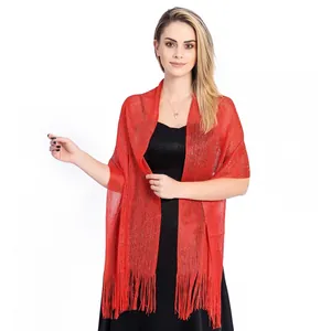 Elegant red lurex evening shawl with fringe detail worn over a black dress by a model.