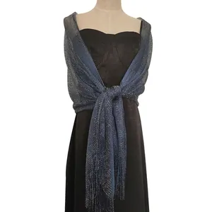 Detailed view of shimmery blue metallic thread shawl with tassels for evening dresses