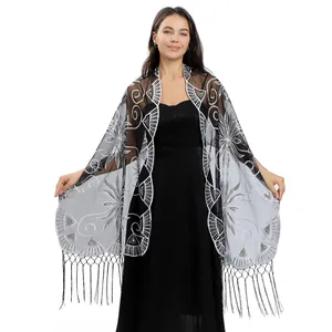 Detailed view of long sheer shawl with silver sequin floral embroidery and tassels