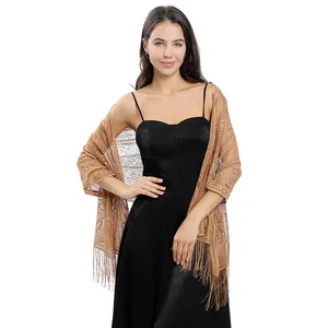 Detailed view of the tan lace evening shawl with elegant floral patterns and fringe.