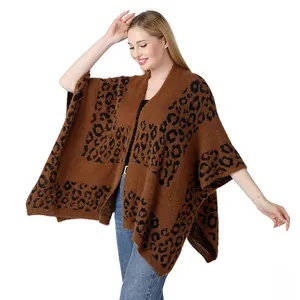 Full view of a brown leopard print knitted poncho on a female model for detail view
