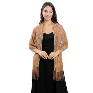 Detailed view of elegant gold lace evening wedding shawl with long fringe tassels
