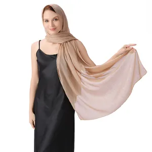 Detail view of champagne chiffon shawl with shimmering silver silk and rhinestones.