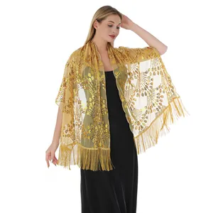 Detail view of golden sequin peacock tail shawl with elegant long fringes for party events