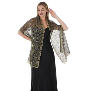 Detail of elegant black lace shawl with gold floral embroidery on evening dress