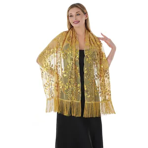 Detail view of luxury golden sequin embroidery shawl with long fringes for formal gowns.