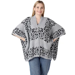 Leopard print knitted poncho with split sides and soft gray texture detail