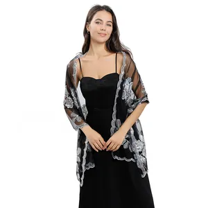 Detail of black sheer shawl with silver peony flower sequin embroidery for evening dresses.