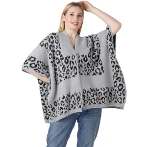 Close-up of leopard print knitted poncho featuring soft grey and black textures