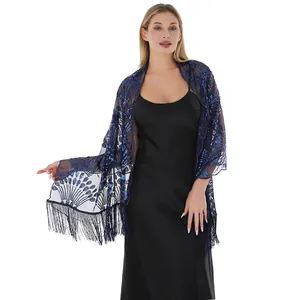 Close-up of elegant navy blue sequin shawl with peacock feather patterns and tassels.