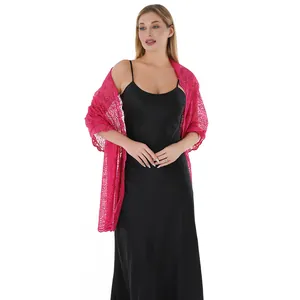 Detailed view of elegant pink sequin embroidered lace shawl worn over a black dress