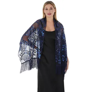 Close-up detail of navy blue mesh shawl with sparkling sequin peacock tail embroidery