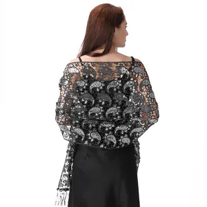 Detailed view of silver sequin paisley lace shawl draped over an evening dress