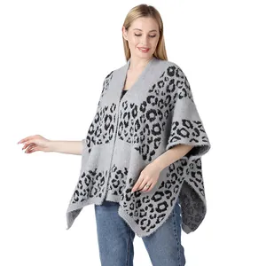 Detail shot of grey leopard knit poncho showing soft texture and split cape design.