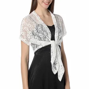 Detailed view of elegant white floral lace bolero shrug tied over a black dress