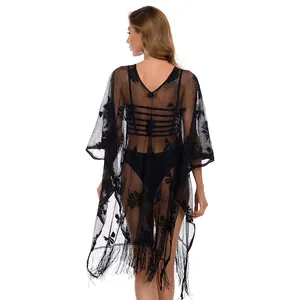 Back view of a sexy black lace beach cover-up with floral pattern and fringe details