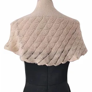 Detailed back view of a beige knitted hollow shawl with scalloped leaf pattern