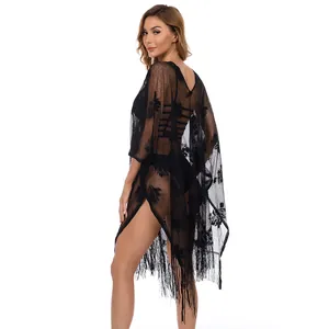 Back view of black lace sheer beach cover-up with floral pattern and fringe trim.
