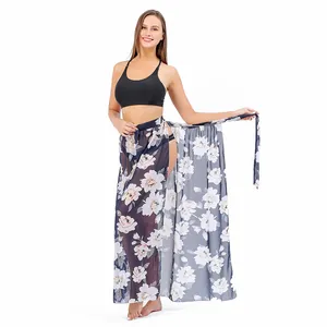 Long floral print chiffon sarong wrap skirt worn as a stylish bikini cover-up for beach