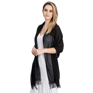 Elegant black chiffon shawl with tassel trim on white lace dress