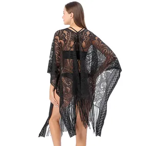 Back view of black lace beach cover-up featuring intricate paisley patterns and tassels.