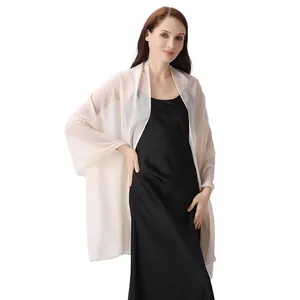 Châle élégant en mousseline beige sur une robe de soirée en satin noir pour événements.