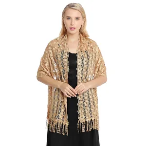 Elegant gold floral lace shawl wrap with tassels over black dress