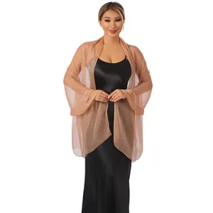 Elegant champagne sheer shawl worn over a black satin dress for formal evening events